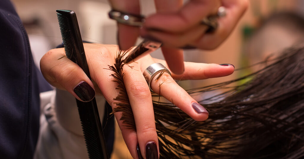 close up of hair stylists hands at work