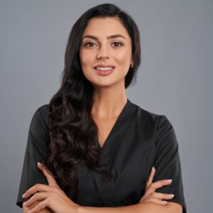 A cosmetologist smiling at camera