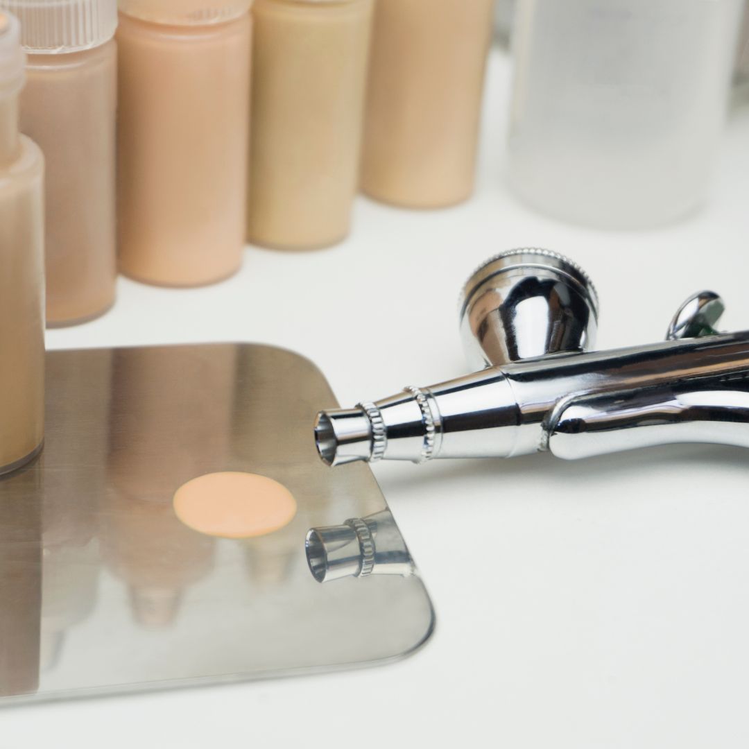 Airbrush with a range of makeup shades. 