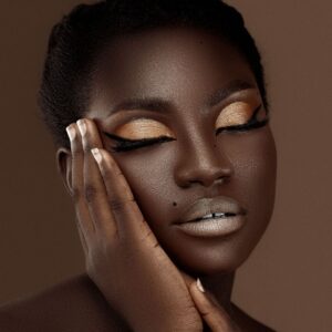 woman with dark skin and glowing pearly makeup
