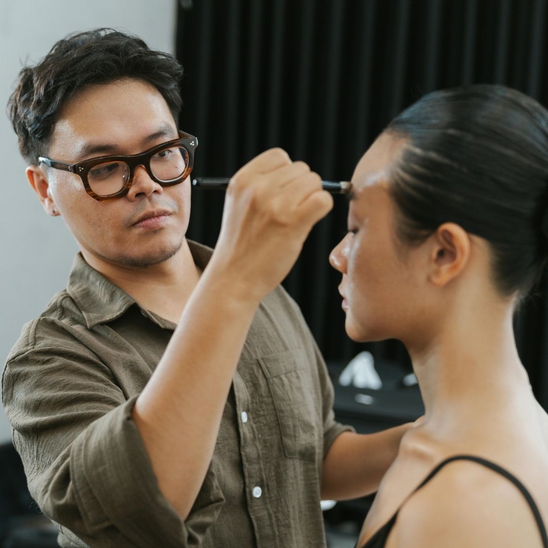 applying makeup to model