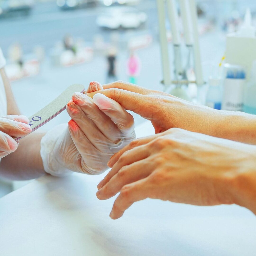 woman getting her nails manicured